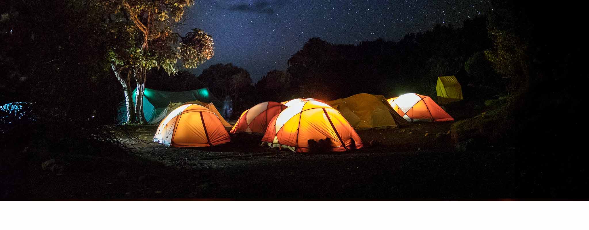 Tents lit up at a festival 