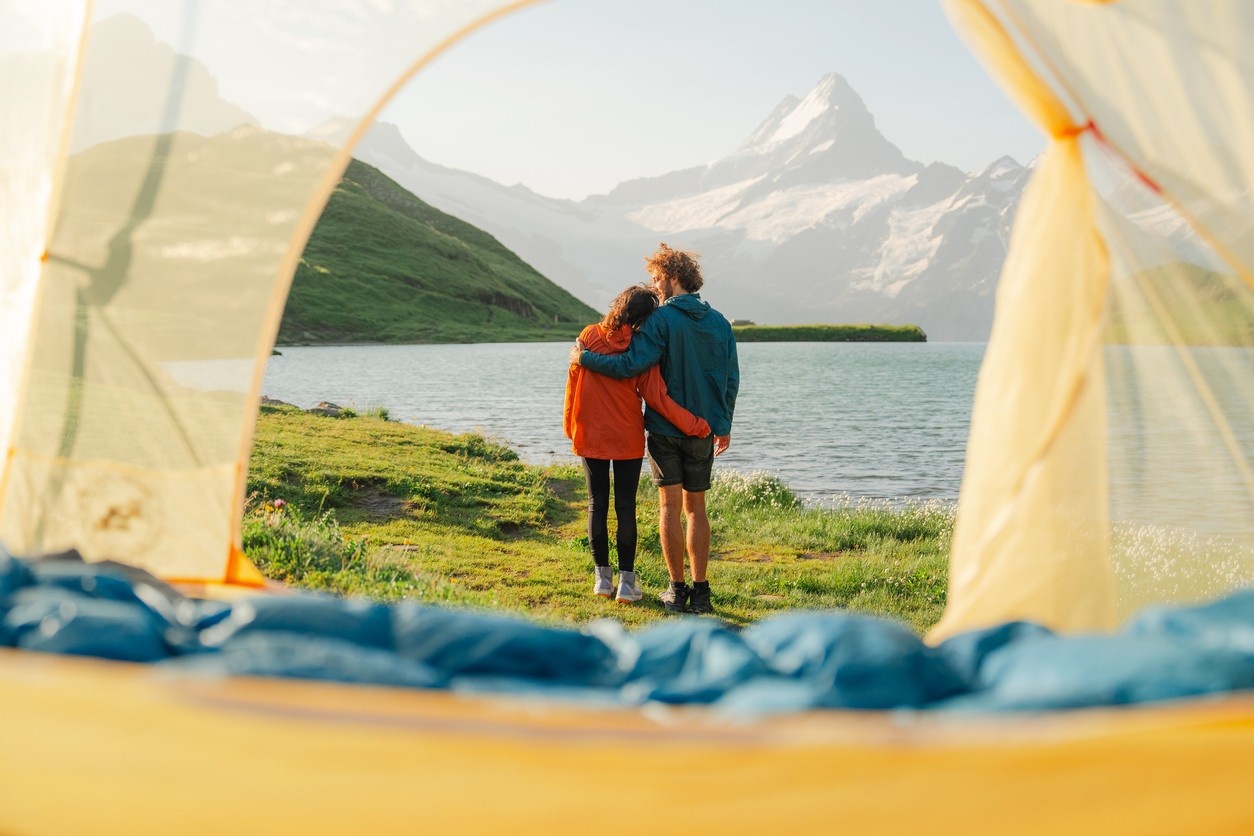 A woman and a man are pitching a tent