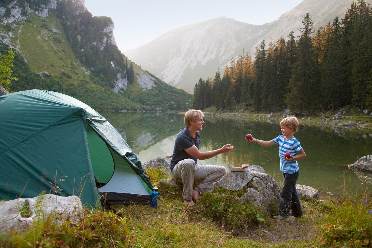A woman and a man are pitching a tent